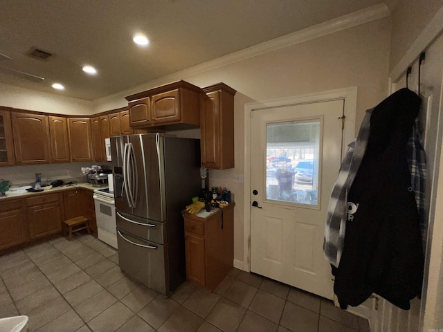 kitchen featuring white range with electric cooktop, stainless steel fridge with ice dispenser, ornamental molding, and light tile patterned floors