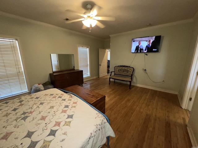 bedroom featuring hardwood / wood-style floors, ceiling fan, and crown molding