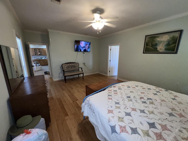 bedroom featuring ceiling fan, ornamental molding, and hardwood / wood-style flooring