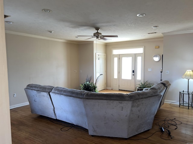 living room featuring ceiling fan, dark hardwood / wood-style flooring, and ornamental molding