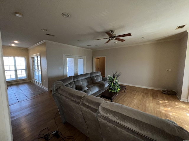 living room featuring hardwood / wood-style flooring, ceiling fan, and ornamental molding