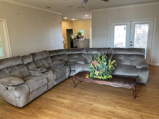 living room with french doors, light hardwood / wood-style flooring, and crown molding