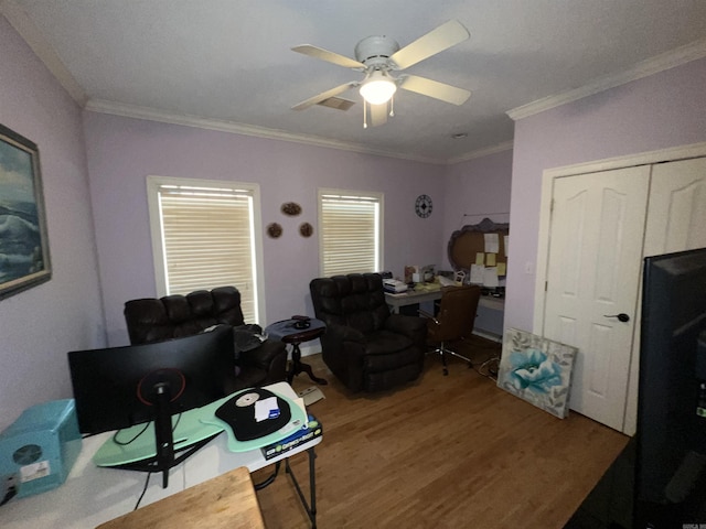 office area featuring ceiling fan, wood-type flooring, and ornamental molding