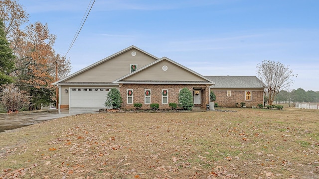 view of front of property with a front yard and a garage