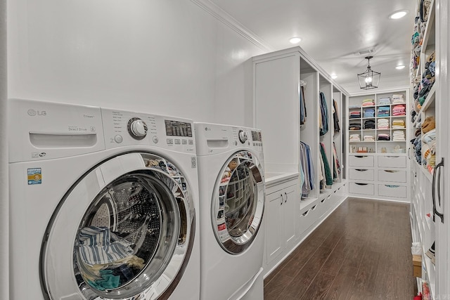 laundry room with dark hardwood / wood-style flooring, crown molding, and washer and clothes dryer