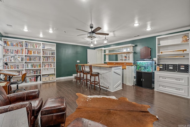 living room featuring dark hardwood / wood-style floors, ceiling fan, and ornamental molding