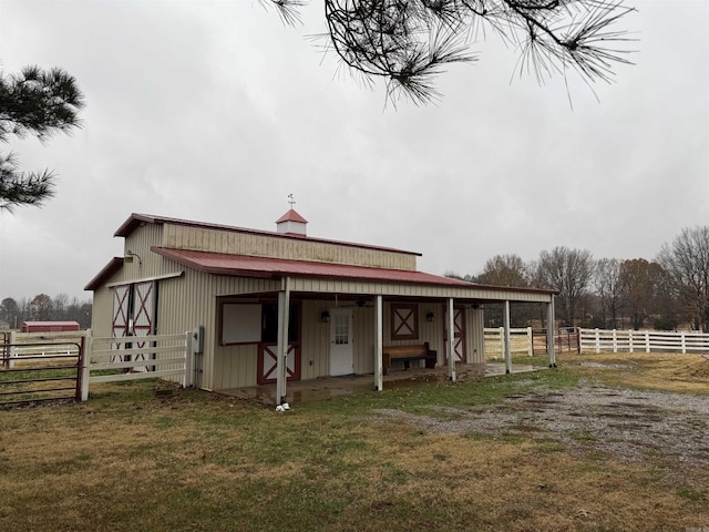 back of house with an outbuilding