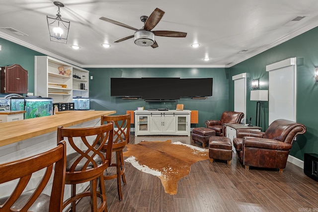 living room featuring ceiling fan, wood-type flooring, and ornamental molding