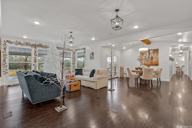 living room featuring lofted ceiling with beams, a healthy amount of sunlight, crown molding, and dark wood-type flooring