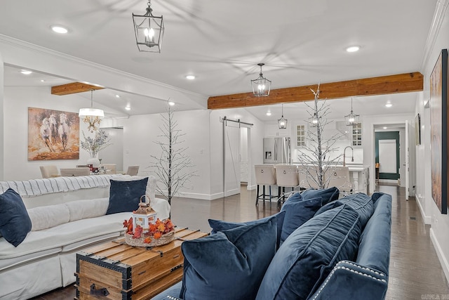 living room featuring crown molding, dark wood-type flooring, sink, a barn door, and lofted ceiling with beams