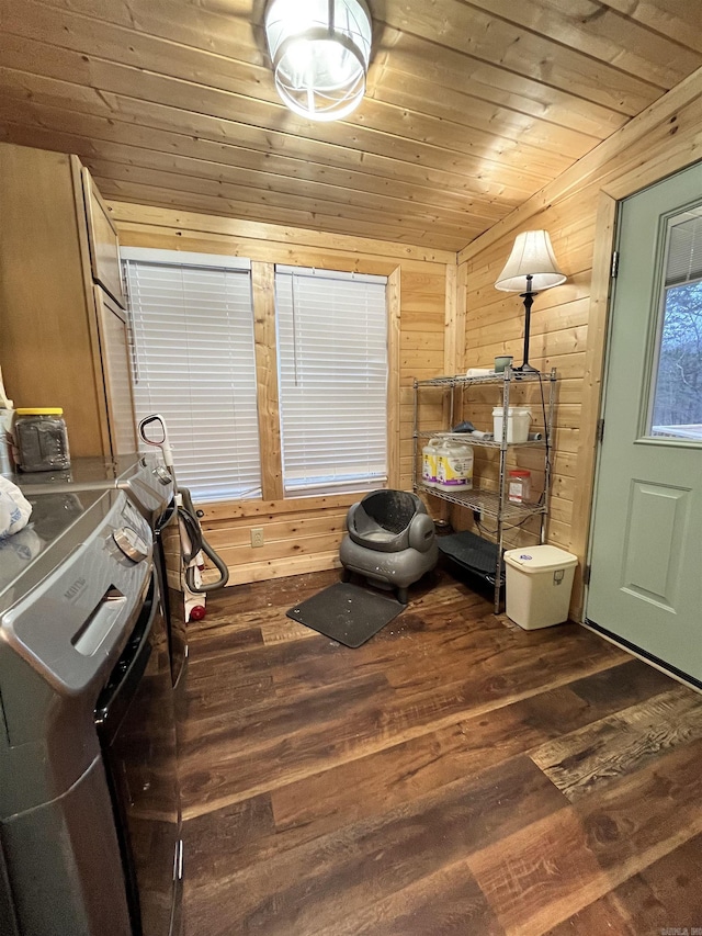 sitting room with dark hardwood / wood-style flooring, washer / clothes dryer, wood ceiling, and wood walls