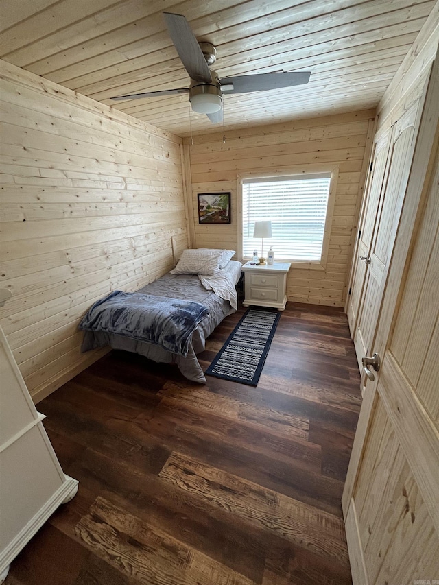 unfurnished bedroom with dark hardwood / wood-style floors, ceiling fan, wooden ceiling, and wood walls