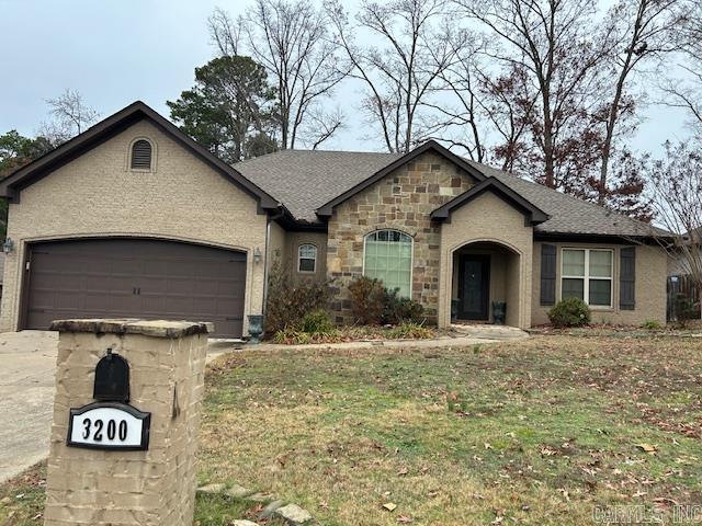 view of front of property featuring a garage and a front yard