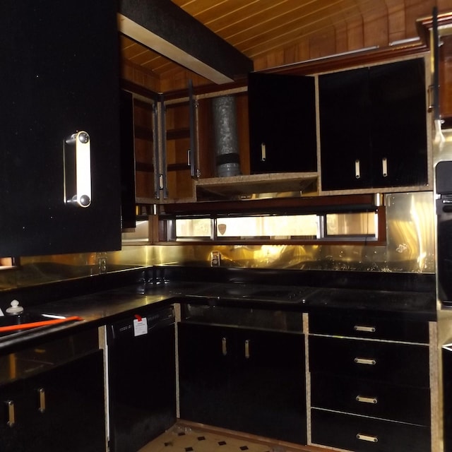 kitchen with beam ceiling, exhaust hood, and black appliances