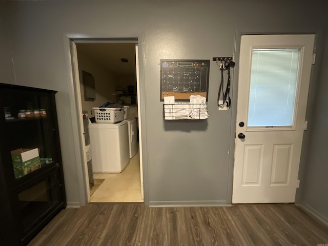 doorway to outside featuring independent washer and dryer and hardwood / wood-style flooring