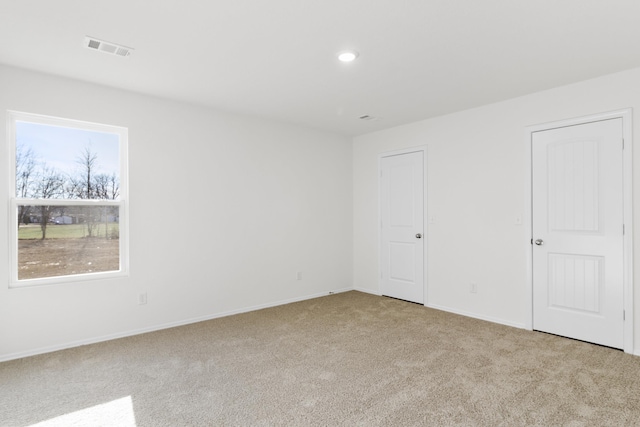 unfurnished bedroom featuring light carpet