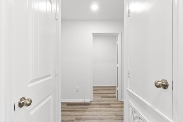 hall with light hardwood / wood-style floors