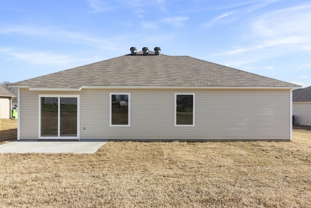 rear view of house with a patio and a yard