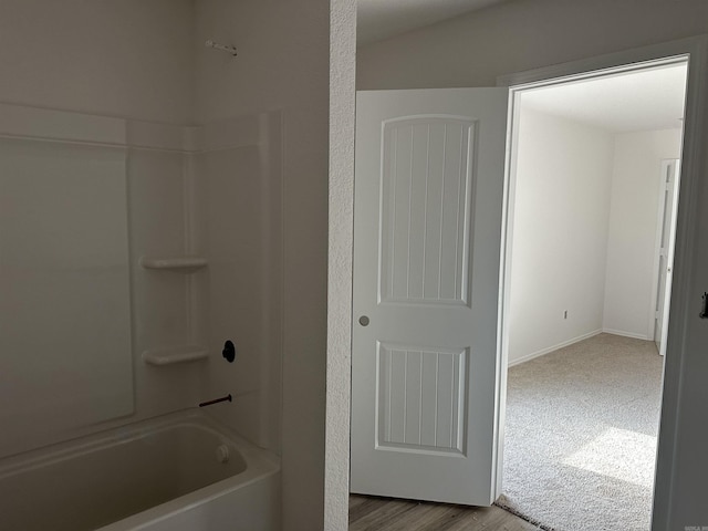 bathroom featuring hardwood / wood-style floors and tub / shower combination