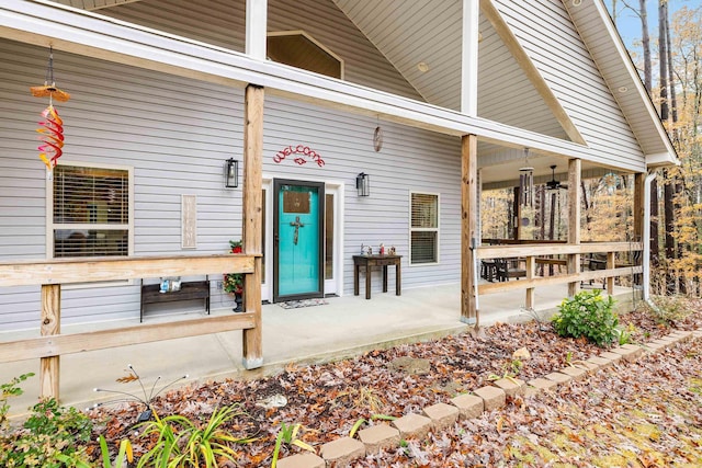 entrance to property featuring ceiling fan and a porch