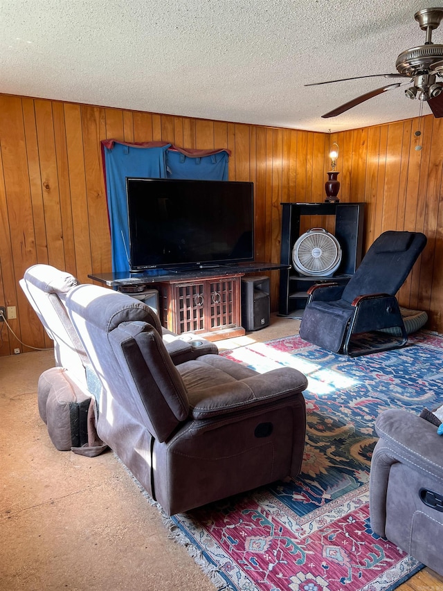 carpeted living room featuring wooden walls, ceiling fan, and a textured ceiling