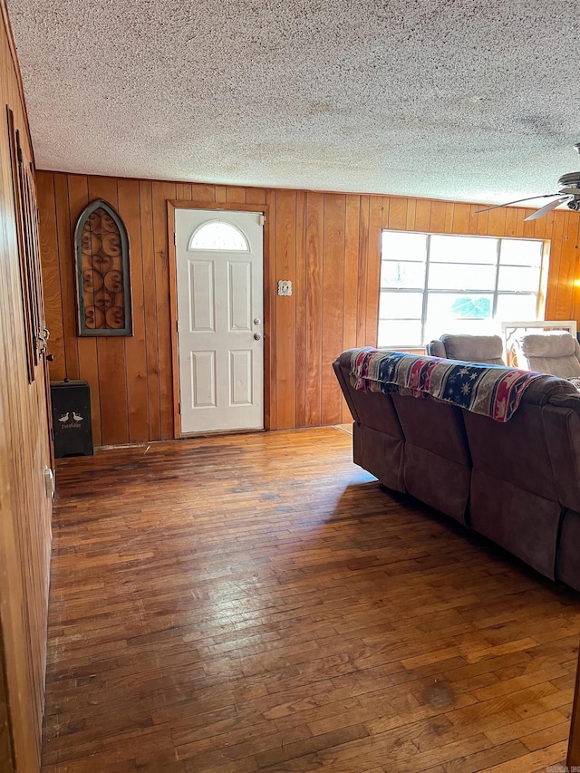 entrance foyer featuring wood walls and dark wood-type flooring