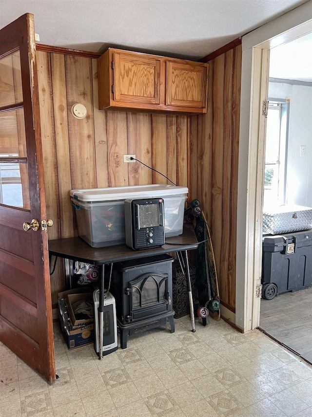 interior details featuring a wood stove and wooden walls