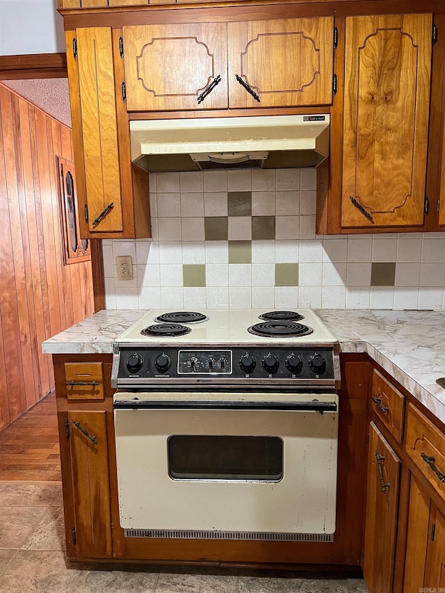 kitchen with backsplash and white range with electric stovetop