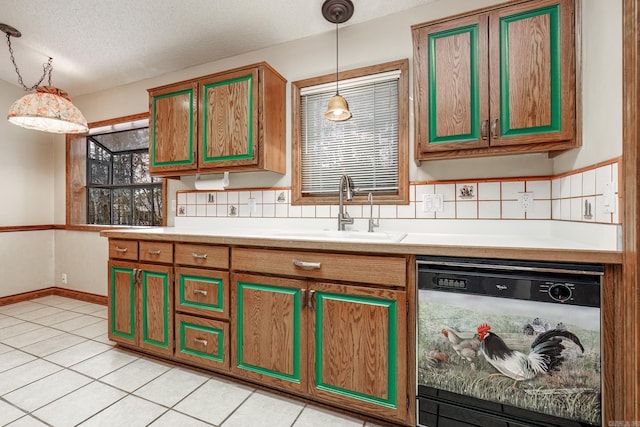 kitchen featuring dishwasher, pendant lighting, a textured ceiling, and sink