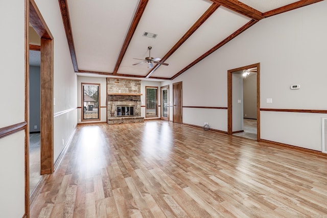 unfurnished living room with lofted ceiling with beams, ceiling fan, and light wood-type flooring