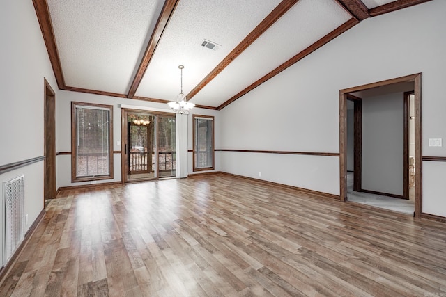 unfurnished living room with vaulted ceiling with beams, light hardwood / wood-style flooring, a textured ceiling, and an inviting chandelier