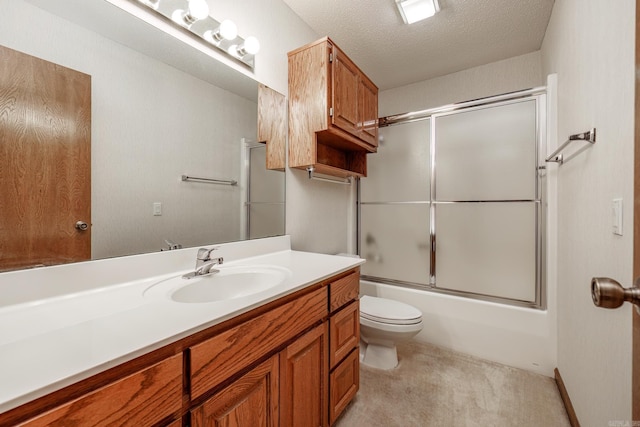 full bathroom featuring toilet, vanity, a textured ceiling, and combined bath / shower with glass door