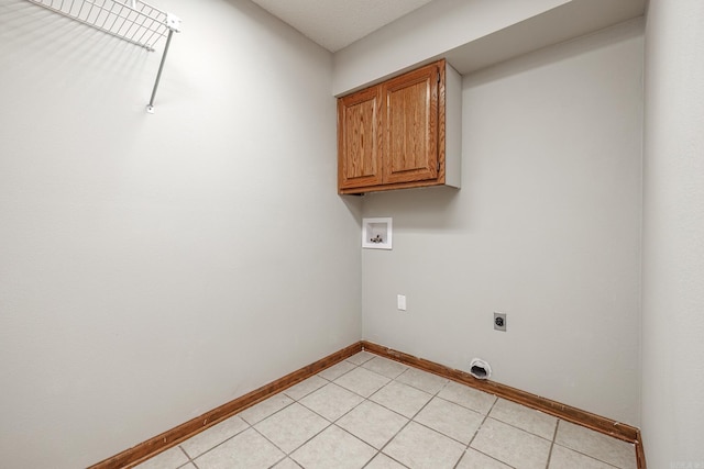 washroom with cabinets, light tile patterned flooring, washer hookup, and hookup for an electric dryer