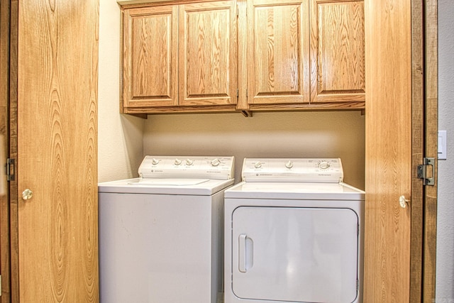 laundry area with cabinets and independent washer and dryer