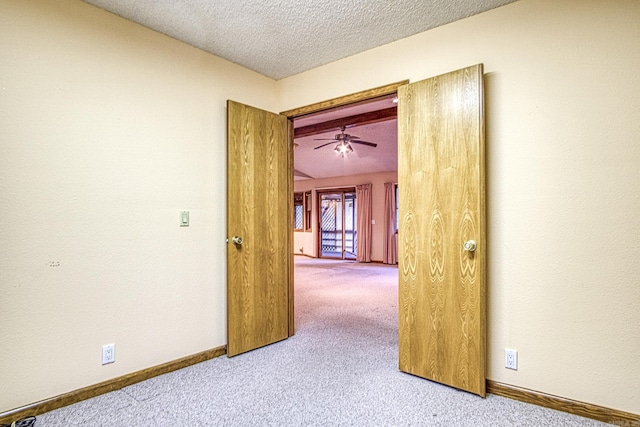 spare room with a textured ceiling and light carpet