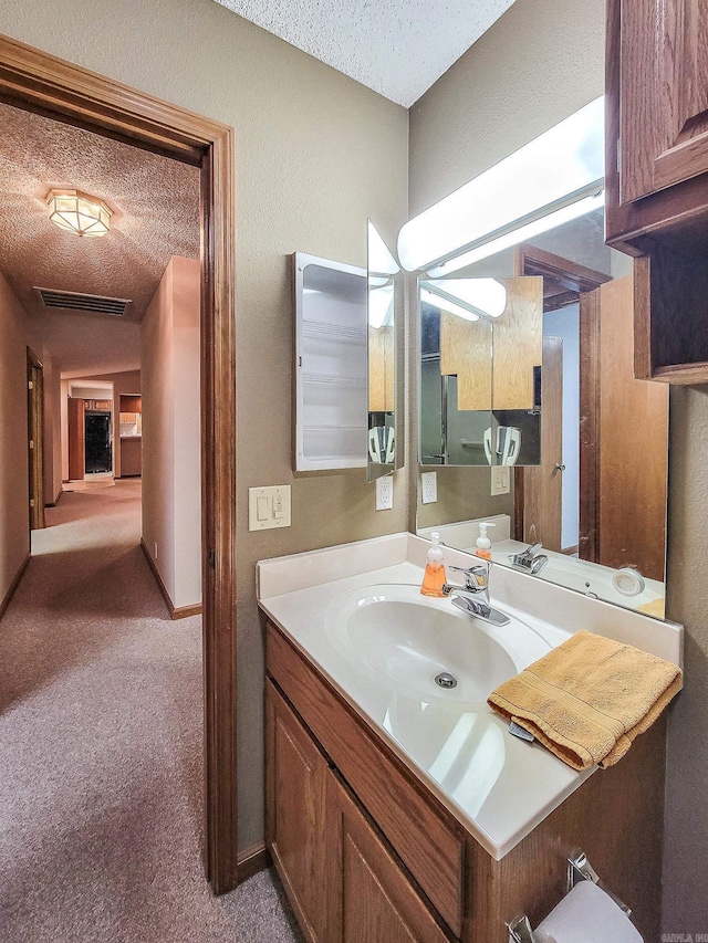 bathroom featuring vanity and a textured ceiling