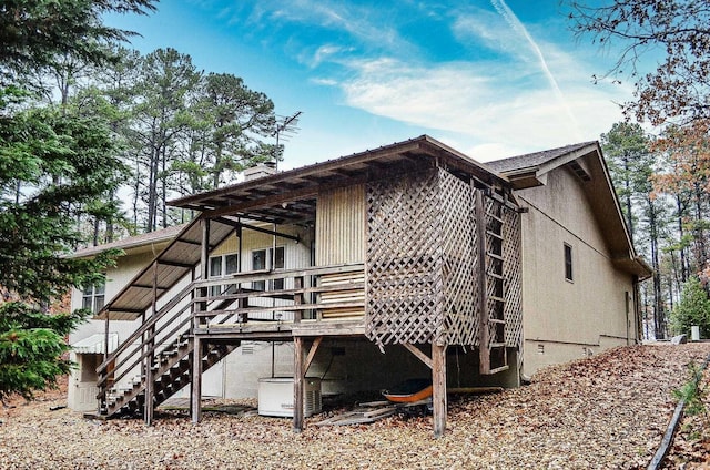 rear view of property featuring a deck