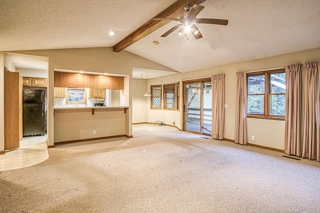 unfurnished living room featuring a textured ceiling, lofted ceiling with beams, ceiling fan, and light carpet