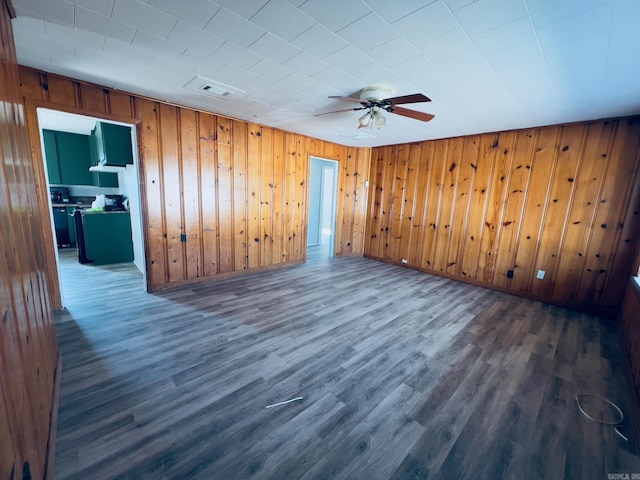 unfurnished room featuring ceiling fan and dark wood-type flooring