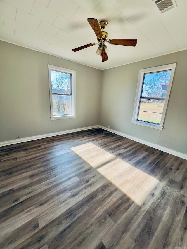 empty room featuring ceiling fan and dark wood-type flooring