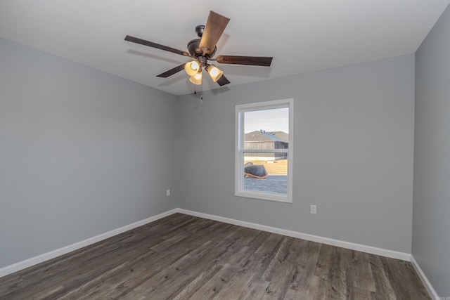 empty room featuring ceiling fan and dark hardwood / wood-style flooring