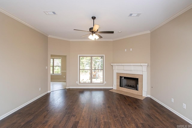 unfurnished living room featuring dark hardwood / wood-style floors, ceiling fan, ornamental molding, and a tiled fireplace