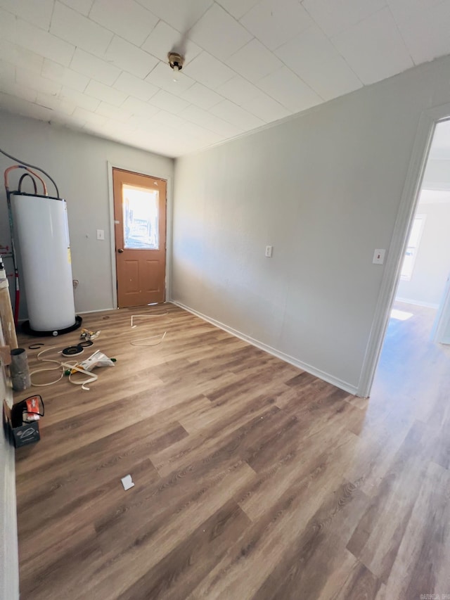 interior space featuring water heater and hardwood / wood-style flooring