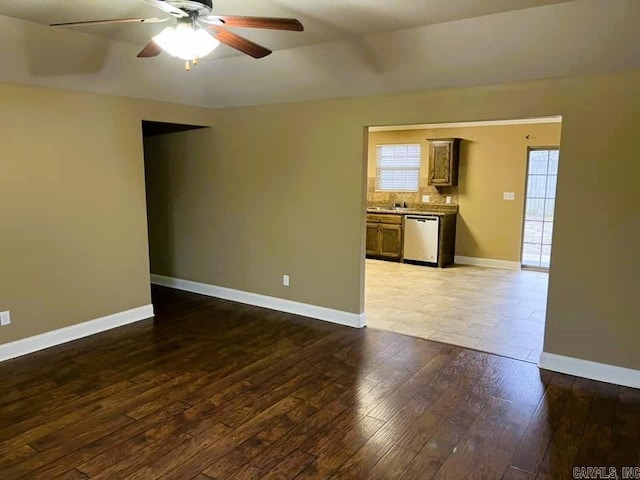 unfurnished room with ceiling fan and dark wood-type flooring