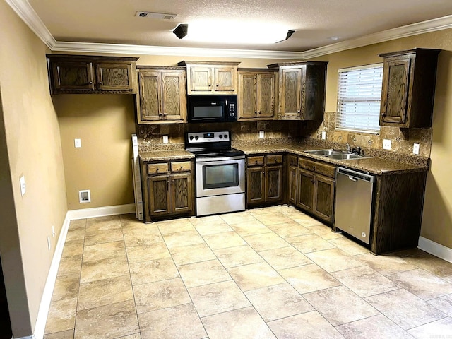 kitchen with backsplash, crown molding, sink, and stainless steel appliances