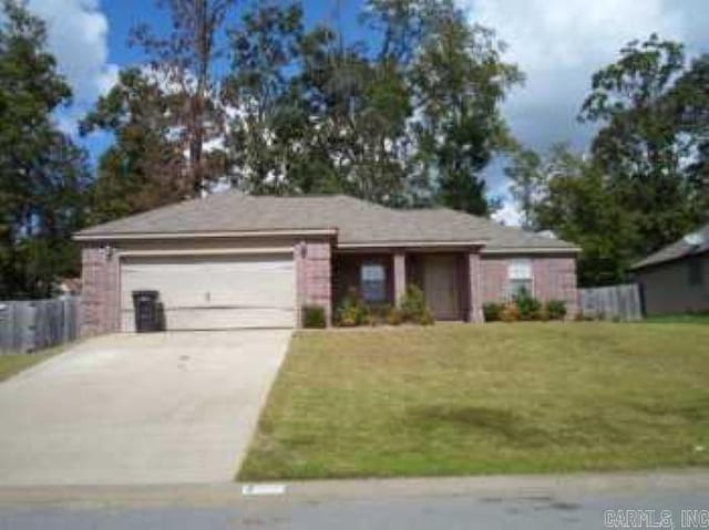 single story home featuring a garage and a front lawn