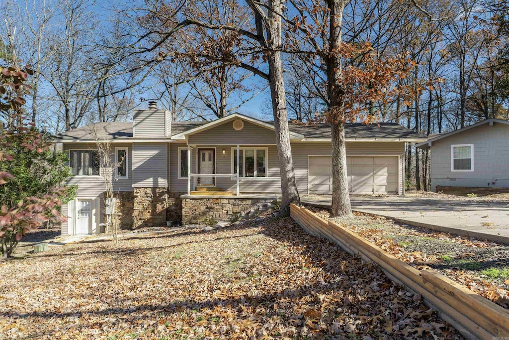 ranch-style home with a garage and a porch