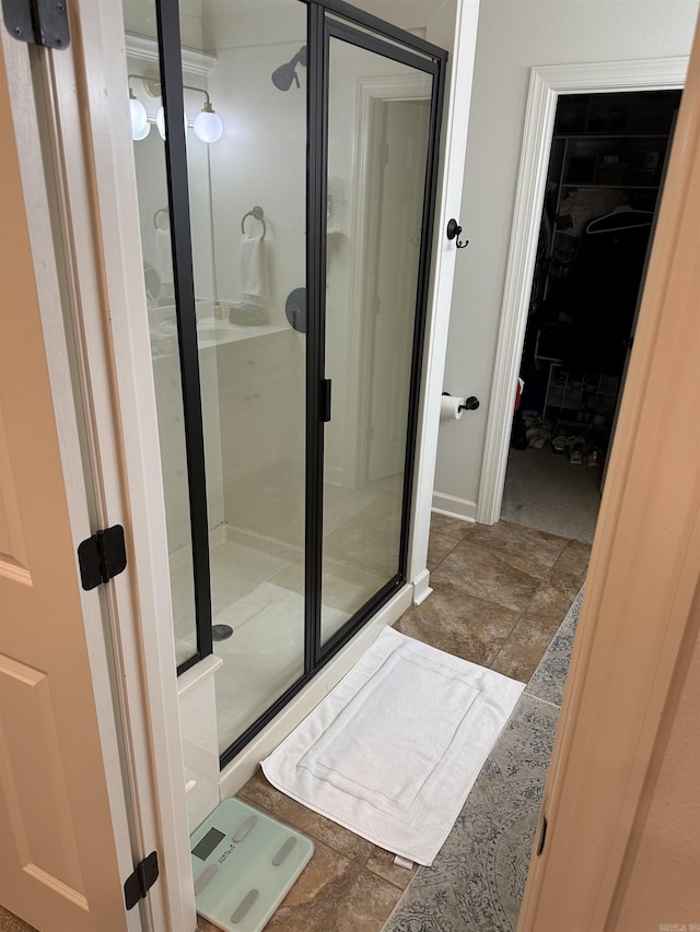 bathroom featuring tile patterned flooring and a shower with door