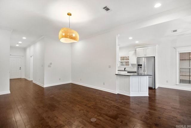 unfurnished living room with crown molding and dark wood-type flooring