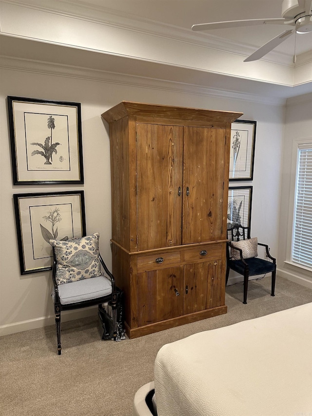 bedroom with ceiling fan, ornamental molding, and light carpet